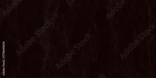 A dark textured background of black slate stone with subtle variations in tone and minimal visibility