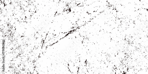 Rough grainy grunge texture featuring distressed speckles and various black particles are surrounding the white background, faded details, and raw vintage surface perfect for edgy design projects.