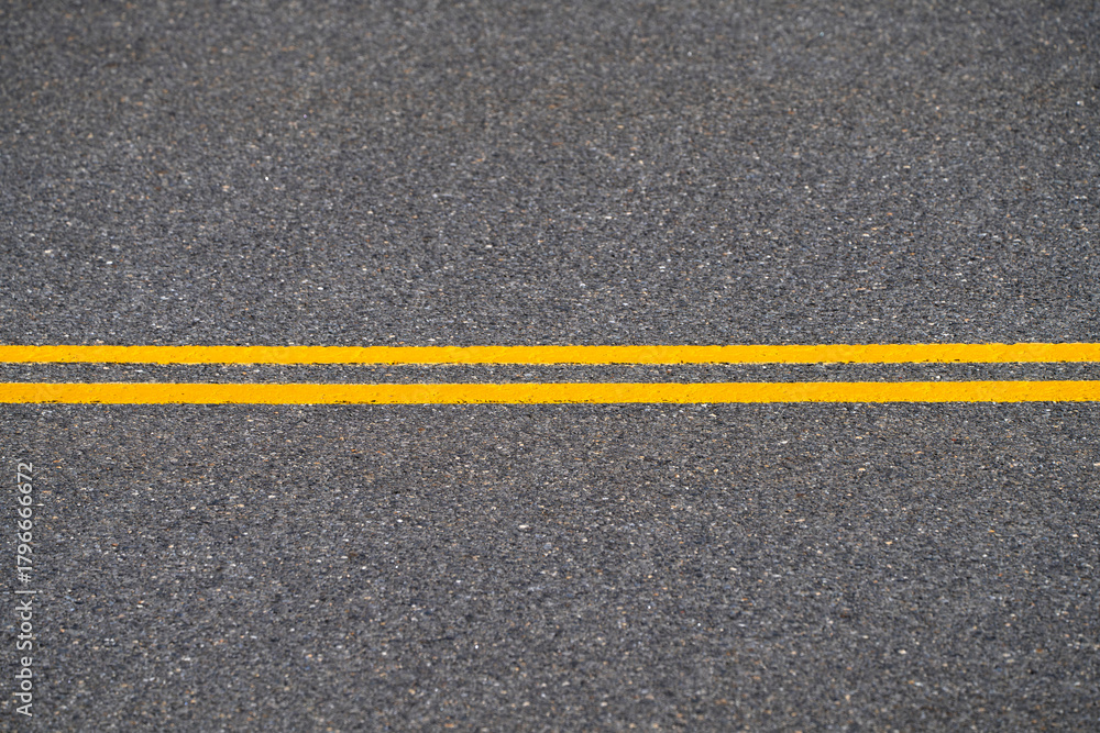 Fototapeta premium double yellow line on the road surface