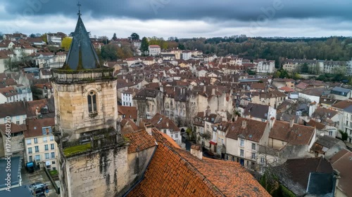 Aerial view captures historic charm of old town Dole in France surrounded by lush green hills, Aerial view of the old town of the city Dole in France on a cloudy afternoon in early spring