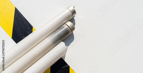A gas-discharge fluorescent lamp on a white background.Broken office lamps.The danger of mercury in everyday life.