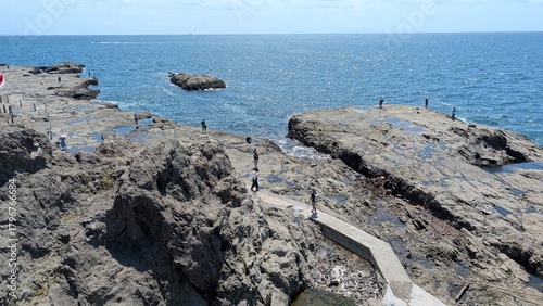 sea and rocks with people
