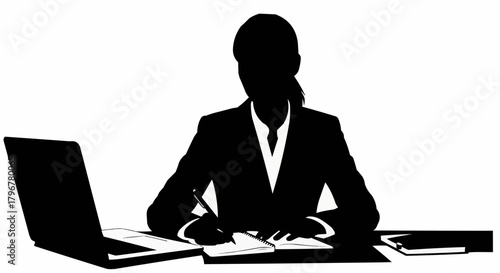 Silhouette of a businesswoman working at her desk with a laptop and notebook.