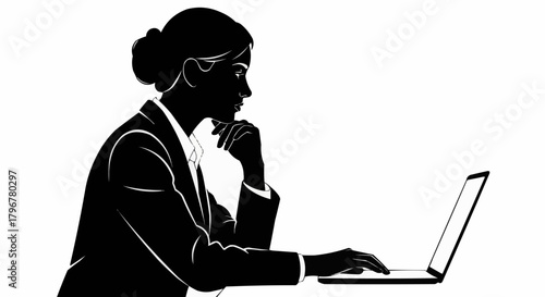 Silhouette of a focused businesswoman working on her laptop.