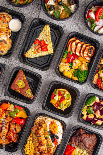 Variety of vibrant meal prep dishes with vegetables proteins salads and desserts arranged in containers