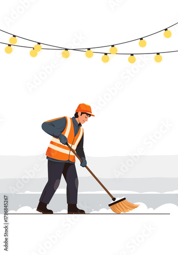 Construction worker sweeping snow under decorative lights  