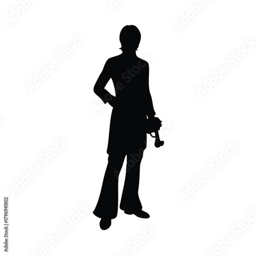 Silhouette of a man holding a camera in a standing position