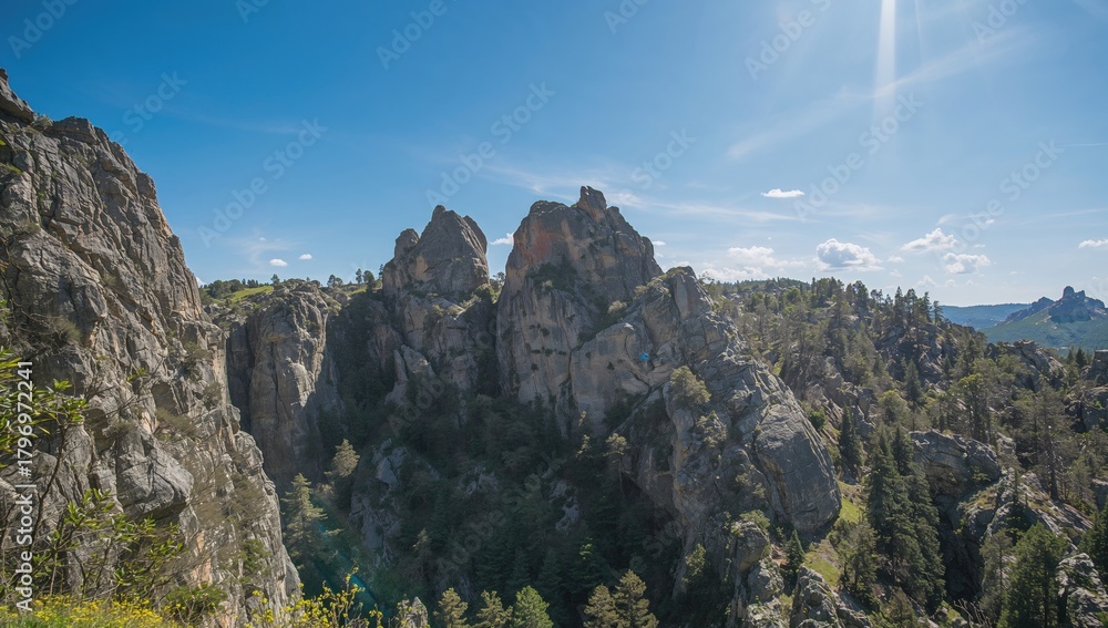 Fototapeta premium Summer mountain landscape showcasing large rock formations under bright sunlight, highlighting outdoor adventure opportunities