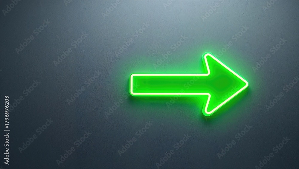 Green neon arrow-shaped pointer on wall, directional guidance in urban settings