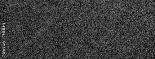close-up texture of smooth, freshly laid asphalt surface with fine granules and a uniform appearance, neutral background, clear negative space, clean composition, balanced framing, minimalist layout