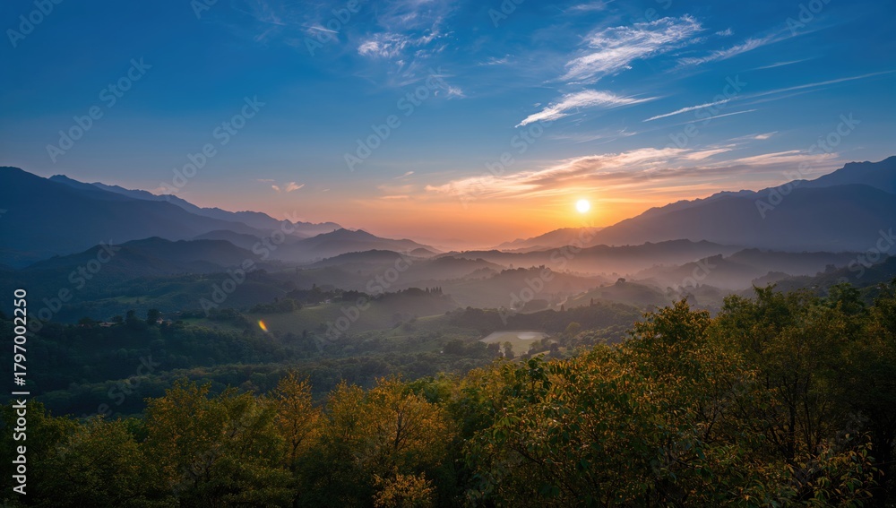 Obraz premium The sun ascends amidst mist and mountains in the early hours, morning haze