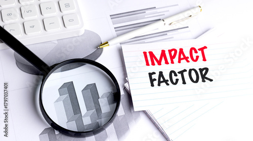 Foto Impact factor phrase on lined paper with magnifying glass, pen, calculator and f