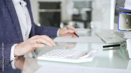 Wallpaper Mural Professional accountant calculating finances and managing paperwork on an office desk, analyzing taxes and budget planning. Audit and taxes in business Torontodigital.ca