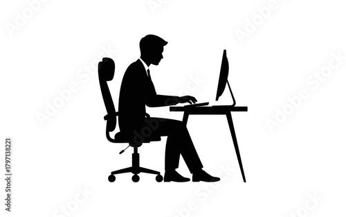 A silhouette of a man sitting at a desk, typing on a compute