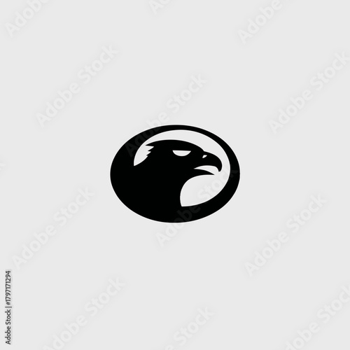 Majestic black eagle head silhouette icon in an oval shape, powerful bird of prey symbol, vector graphic design element.