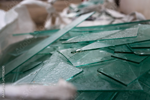 Sharp, frozen sheet glass waste in big white bags for recycle.