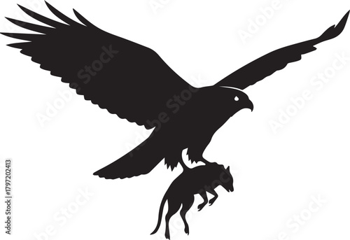 Majestic silhouette of a hawk in flight carrying prey in its talons