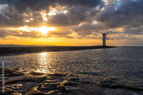 Fototapeta Naklejka Na Ścianę i Meble -  view on windmill in Swinoujscie with Baltic sea during sunset
