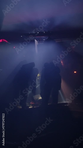 Rescue forces search for survivors inside a dark tunnel using flashlights