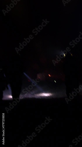 Rescue forces search for survivors inside a dark tunnel using flashlights