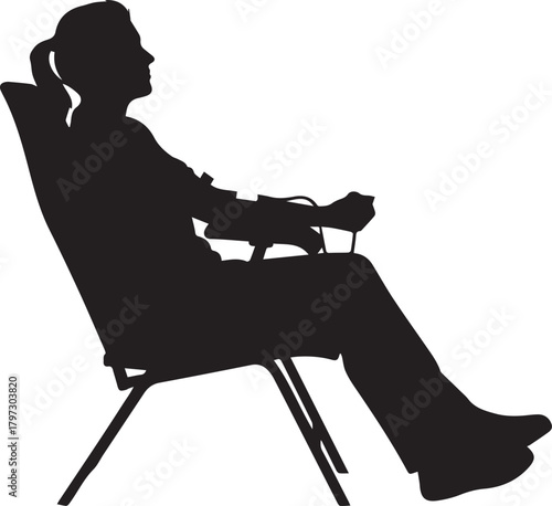 Silhouette of a woman relaxing in a folding chair enjoying leisure time outdoors