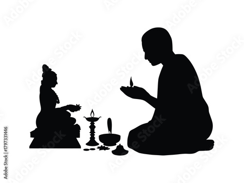 Hindu priest performing ritual with deity and lamp offering
