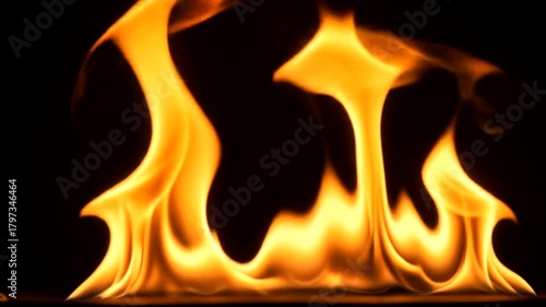 Vibrant orange and yellow flames dance against a dark background.