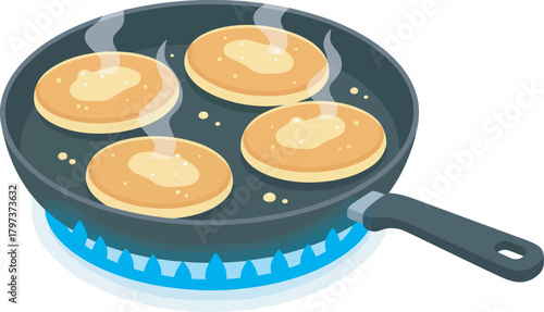 Four pancakes are being cooked in a pan on a blue gas flame, with butter melting on top.