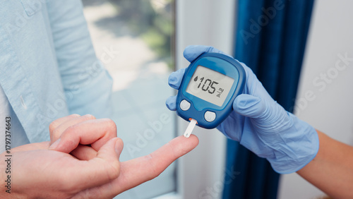 Doctor making blood sugar test. Hands with gloves on medical background
