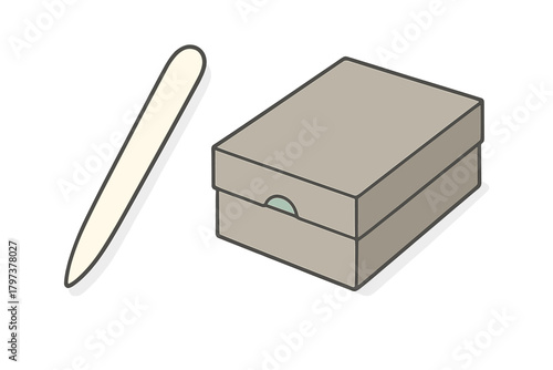 Bone folder creasing tool placed next to a closed rectangular storage box
