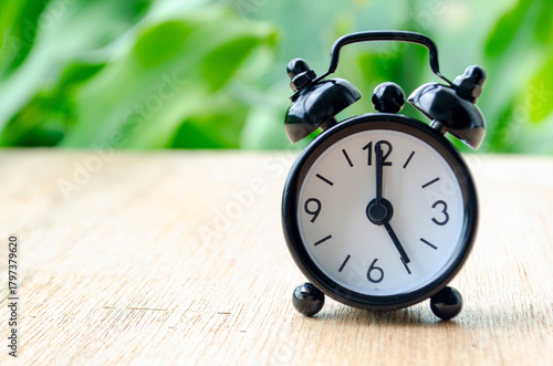 Alarm clock pointing at 5 pm with customizable background space for text or ideas. Time concept.