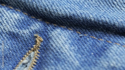 Close up of blue denim highlights weave and seam