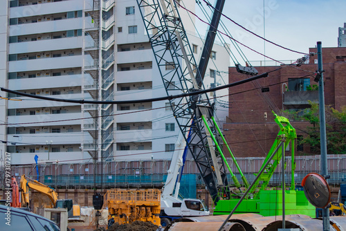 A cityscape of moving crane at the under construction in Tokyo telephoto shot