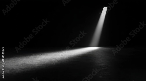 Photo of room with light shining on floor in black and white, designed for dramatic contrasts and elegant themes.