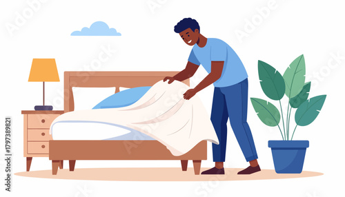 Smiling Man Making Bed, Tidying White Duvet, Wearing Blue Shirt and Pants.