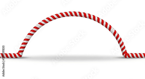 Red  white twisted rope forms an arch casting a soft shadow on a white surface