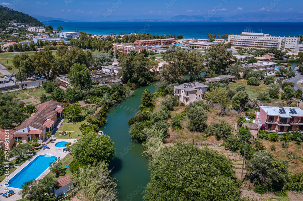Naklejka premium Drone view of a canal separating Moraitika and Messonghi villages on a Corfu Island, Greece