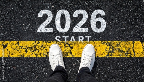 A person in white sneakers stands at the 2026 start line on an asphalt road, ready for a new year's journey