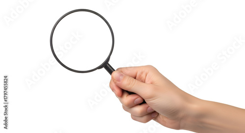 Hand Holding Magnifying Glass Against Black Background