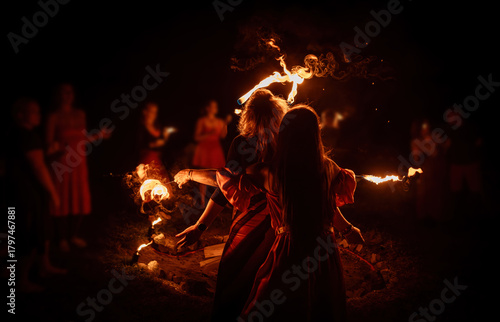 An enchanting fire dancer beautifully showcases her talent with mesmerizing flames during a performance.