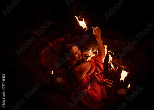An enchanting fire dancer beautifully showcases her talent with mesmerizing flames during a performance.