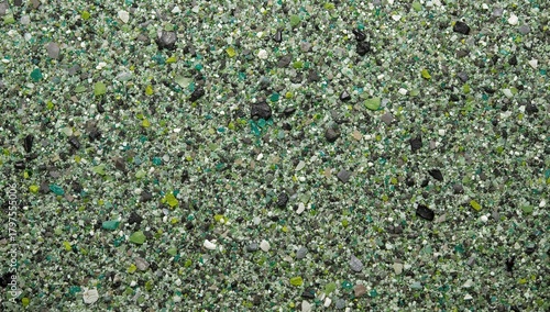Close-up view of decorative epoxy floor featuring quartz sand in green, grey, white, and black hues, showcasing durability and aesthetic appeal