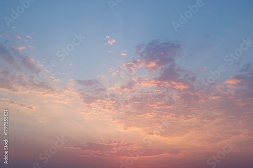 Soft pastel hues of dawn and dusk skies with vibrant clouds, no birds present