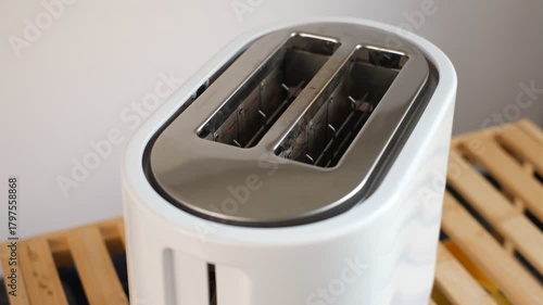Person turns on toaster and it heats up close-up