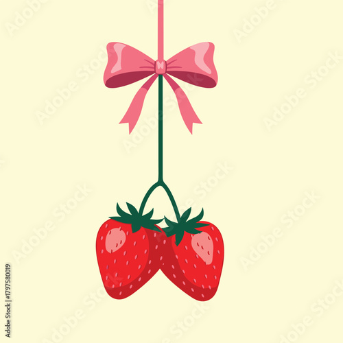 Sweet red strawberries hanging with a pink ribbon bow as a cute decoration.