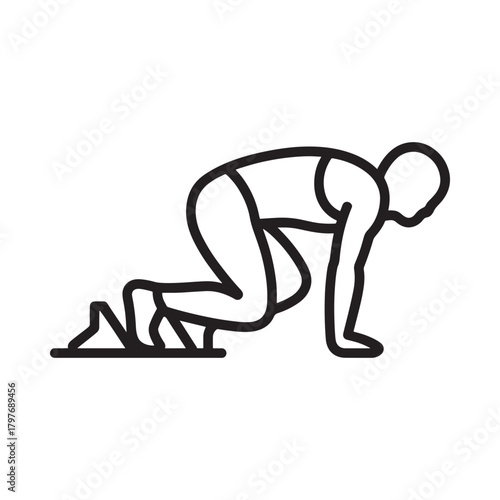 Runner in starting blocks ready to sprint