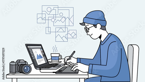 Young Male Graphic Designer Working on Laptop with Graphics Tablet.