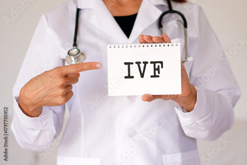 IVF, medical concepts, female doctor pointing to the acronym written in her medical notebook