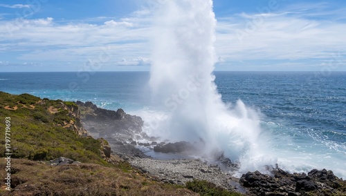 Water erupts from blowhole along the coastline of Espanola Island, showcasing natural marine activity
