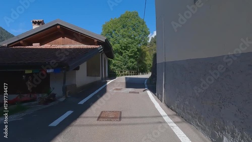 POV bike ride through narrow streets of Pieve di Ledro in Trentino, Italy
